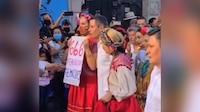 ‘666 feminicidios’: Mujer protesta con cartel ante el gobernador de Oaxaca